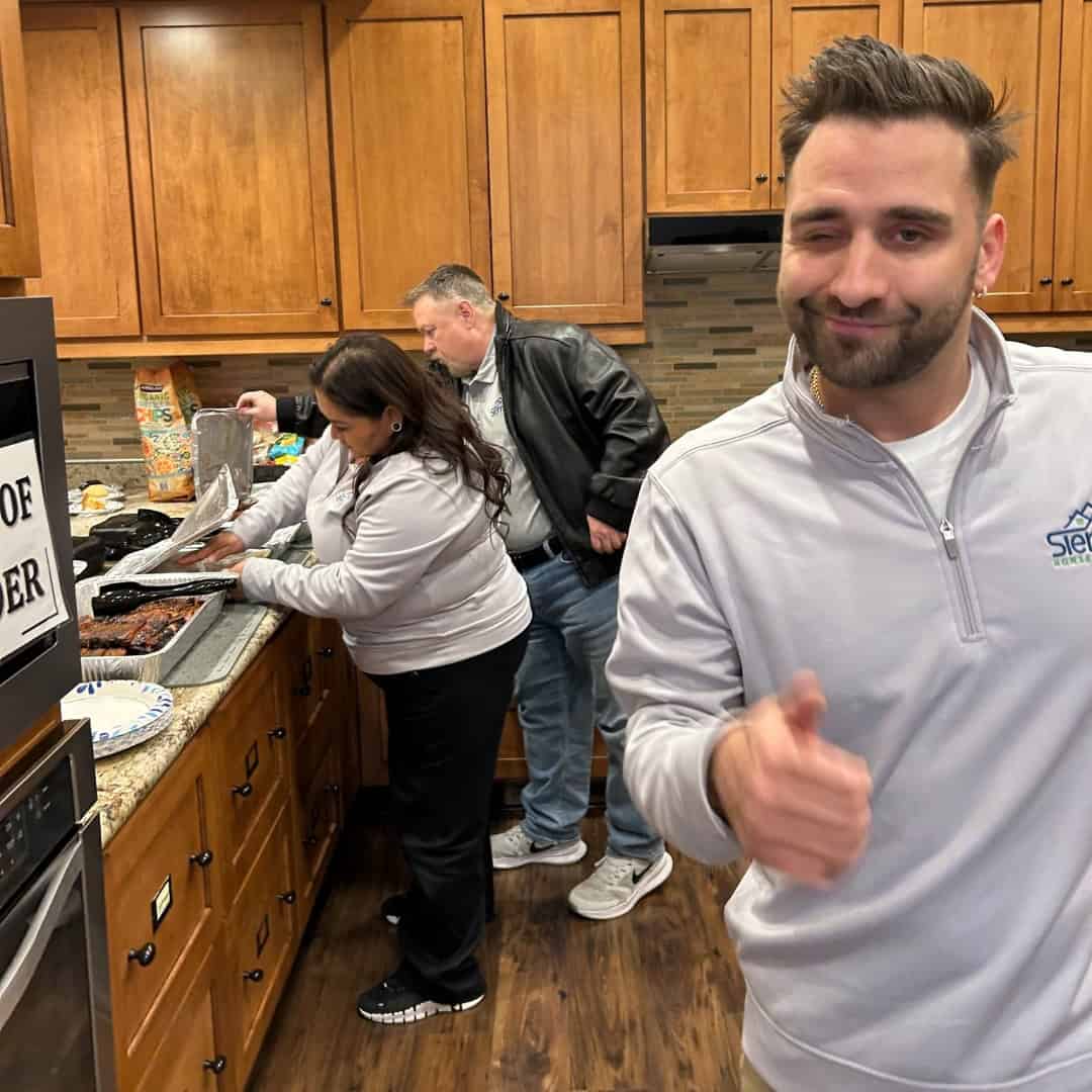 The Sierra Homebuyers team serving a BBQ dinner in the Veterans Guest House kitchen